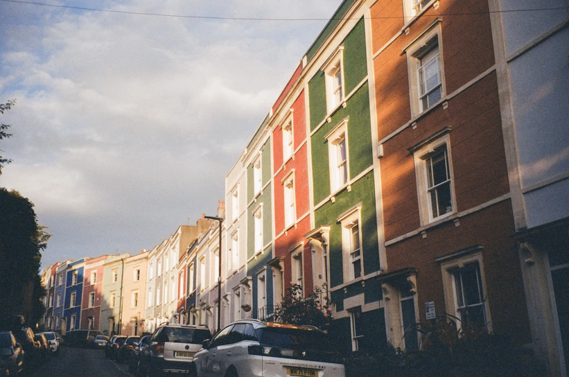 A cozy British street lined with colorful houses under a soft morning light.