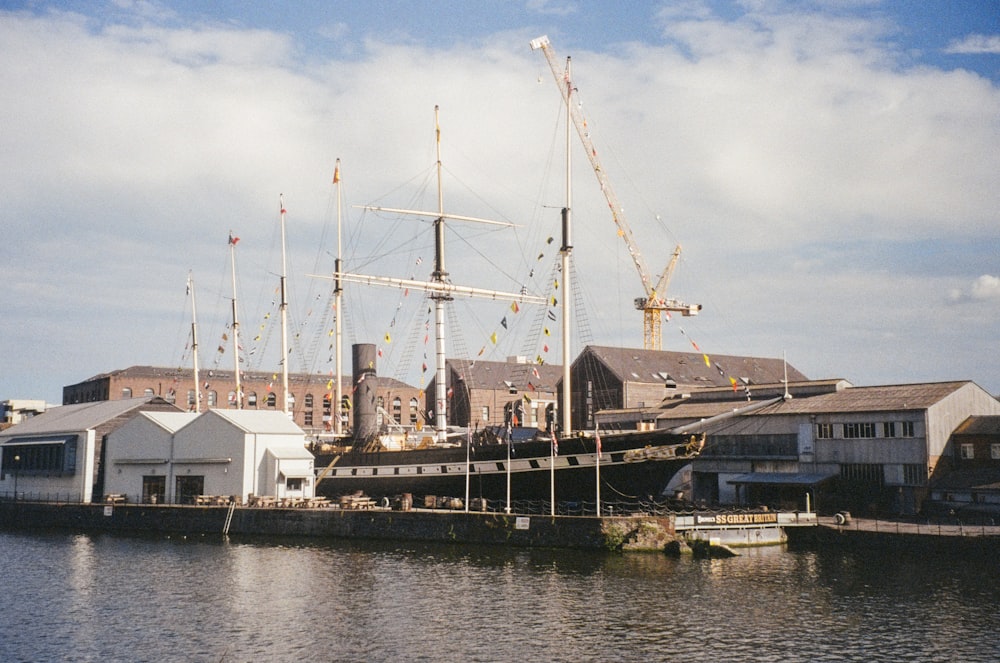 a large boat docked in a harbor next to buildings