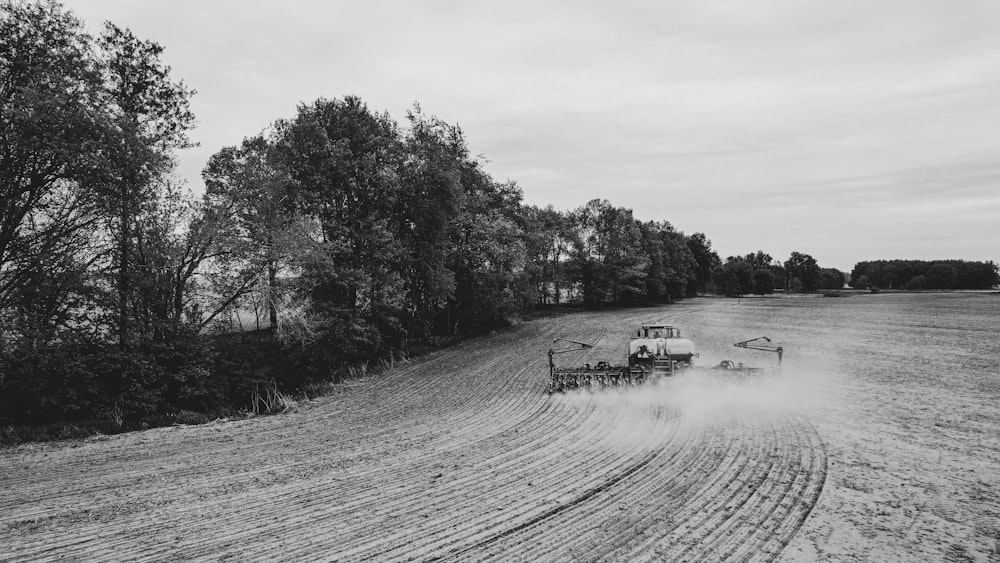 a tractor plowing a field in the middle of the day