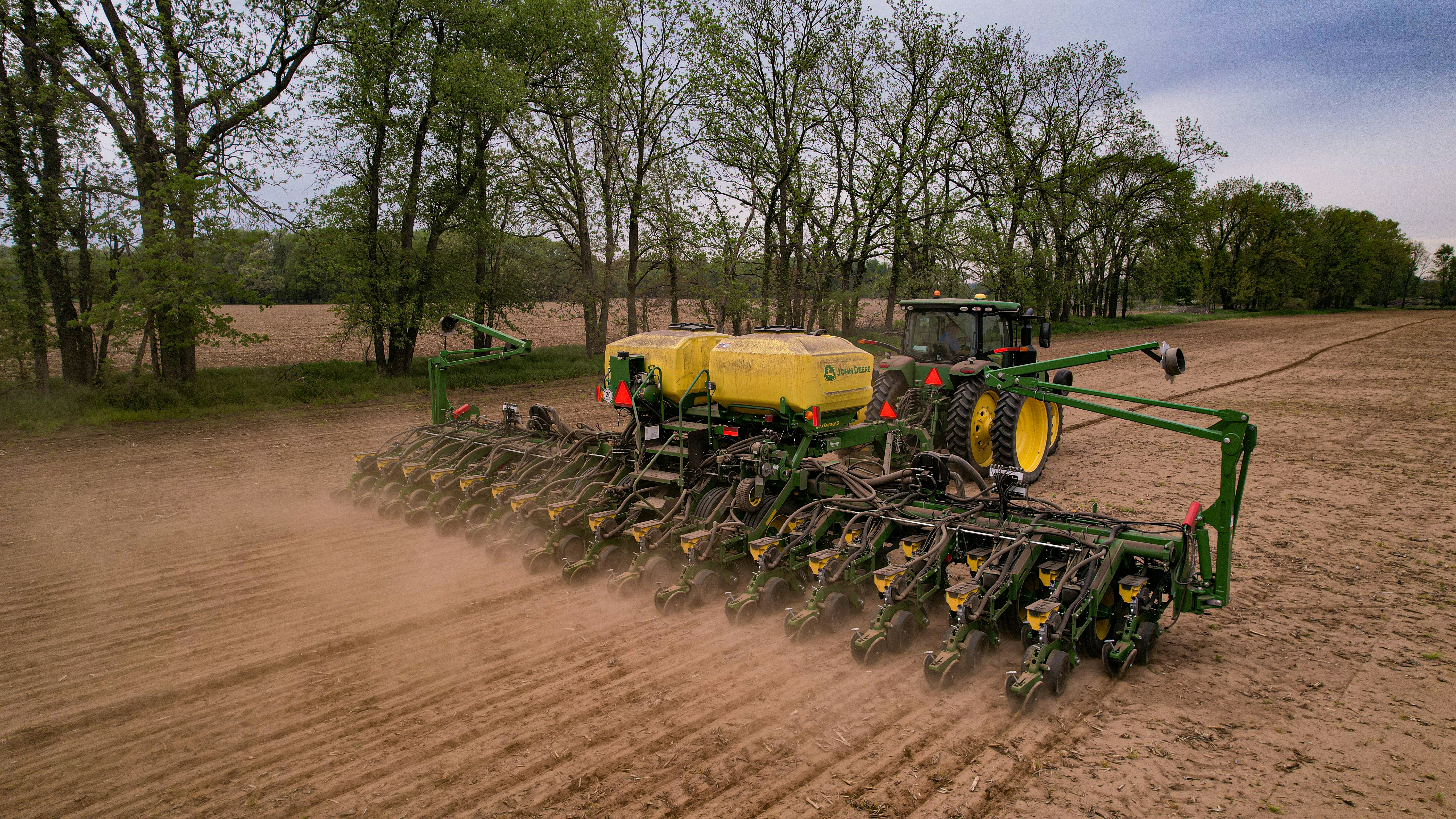 a tractor is plowing a field of dirt