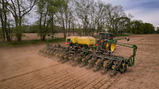a tractor is plowing a field of dirt