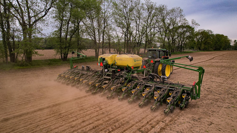 a tractor is plowing a field of dirt