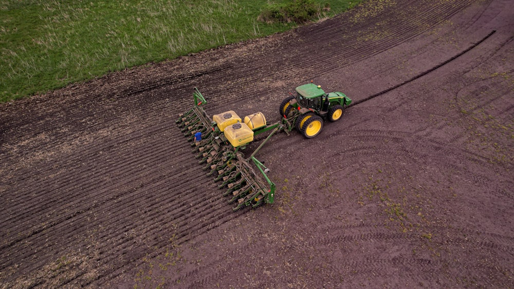 a tractor plowing a field in the middle of the day