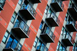 Modern apartment building facade with balconies overlooking a bustling Buenos Aires street.