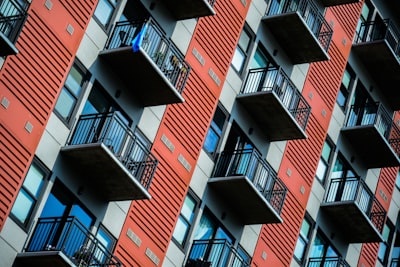 a tall red building with balconies and balconies