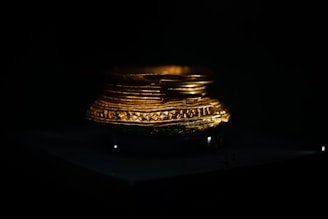 A brass bowl filled with golden ghee, softly lit with natural light highlighting its smooth texture.