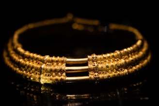 Close-up of a beautifully crafted gold bracelet with intricate design.