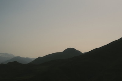 A minimalist digital design showcasing a serene mountain landscape in soft tones.