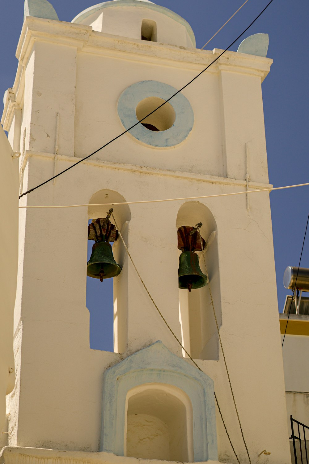 a bell tower with two bells on each of it's sides