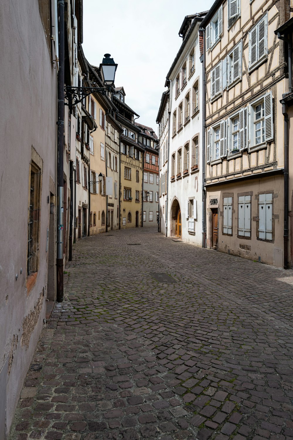 a cobblestone street lined with old buildings