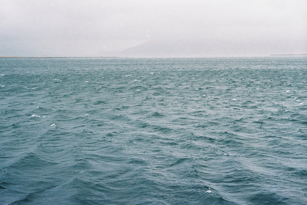 a large body of water with a small island in the distance