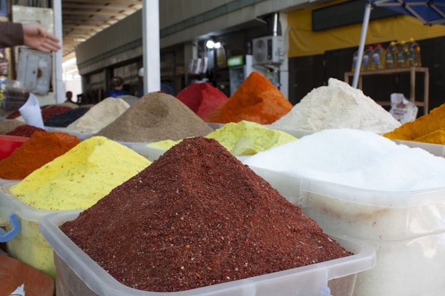 Close-up of vibrant spices neatly packed in export-ready containers.