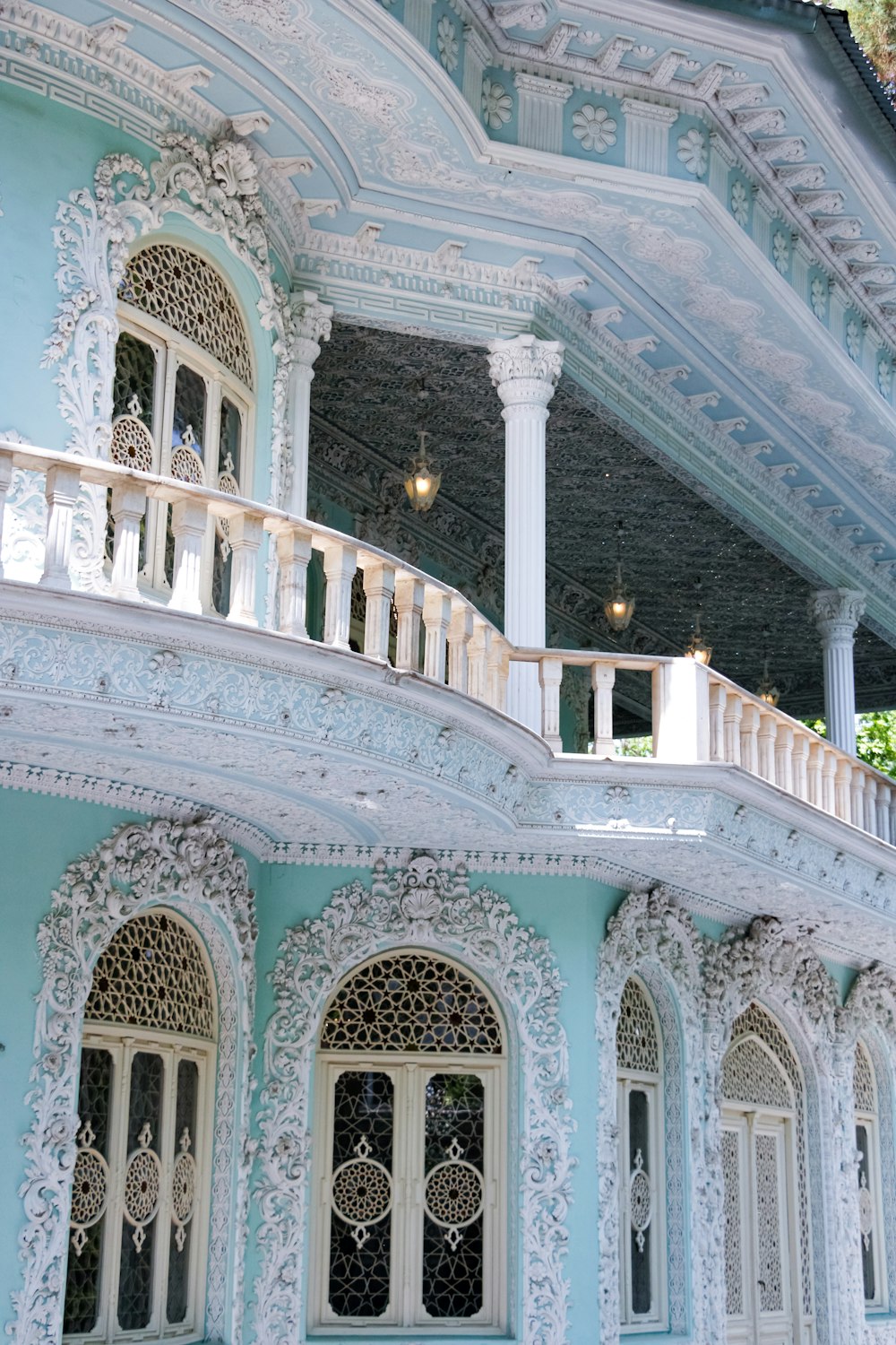 a blue and white building with a balcony and balconies