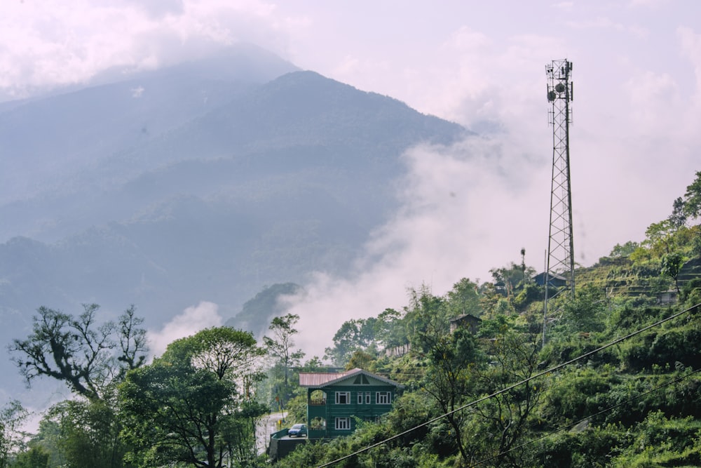 a house on a hill with a mountain in the background