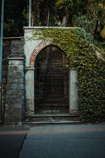 Classic villa entrance with stone archways and lush greenery