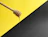 Close-up of a wooden honey dipper dripping golden honey against a backdrop of snow-capped Himalayan peaks.