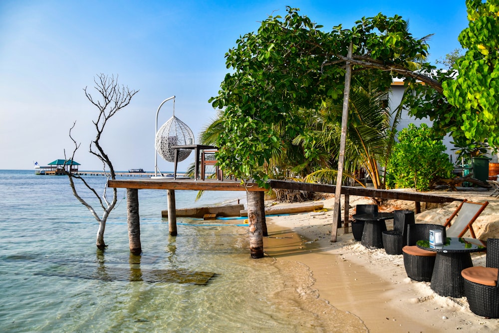 a beach with chairs and a table on it