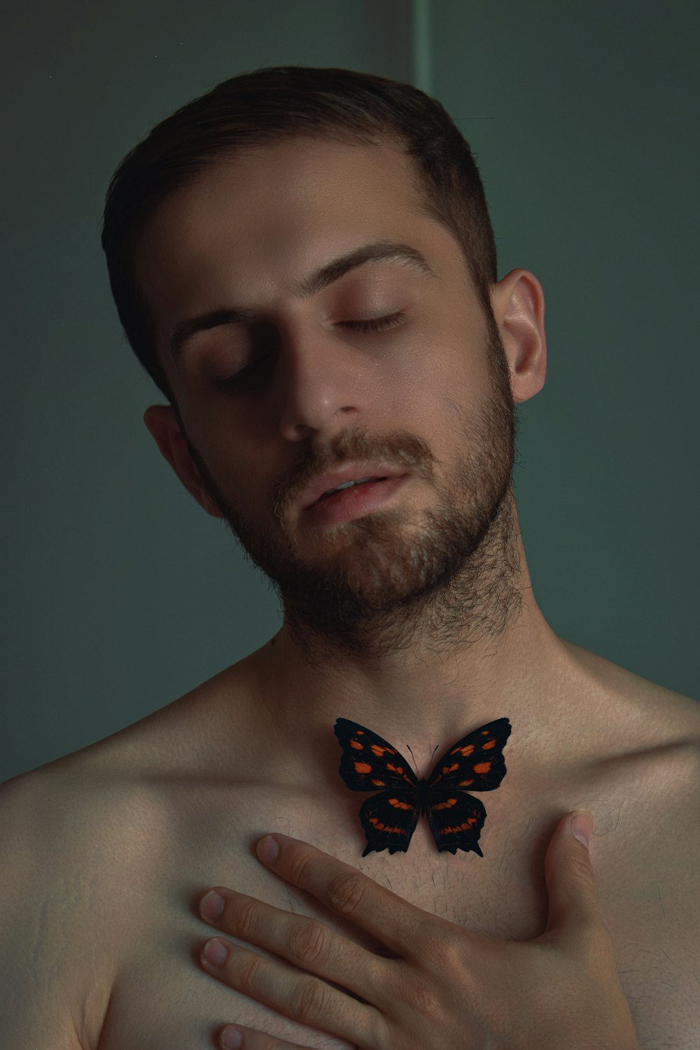 a man with a butterfly on his chest