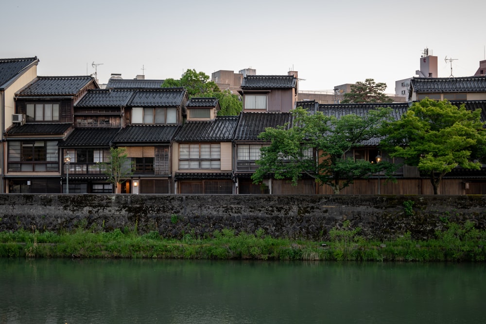 a body of water in front of a row of buildings