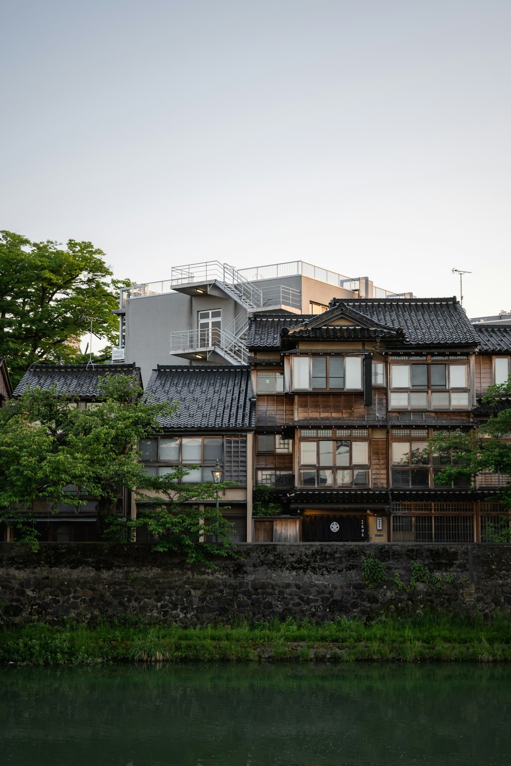 a building with a lot of windows next to a body of water