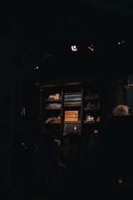 A neatly organized storage unit filled with various pieces of furniture under soft lighting.