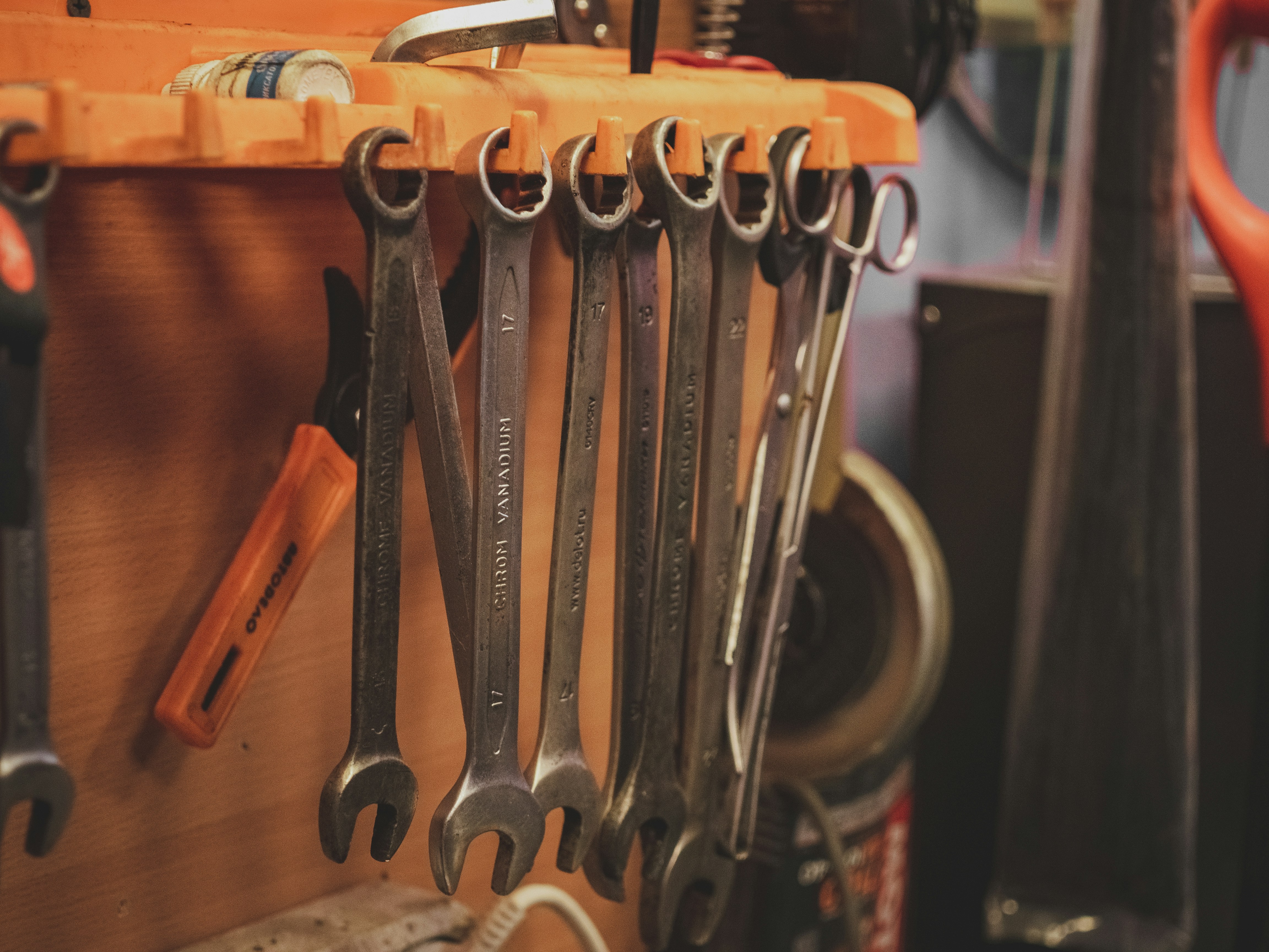 A bunch of wrenches hanging on a wall photo Free Tools Image on Unsplash