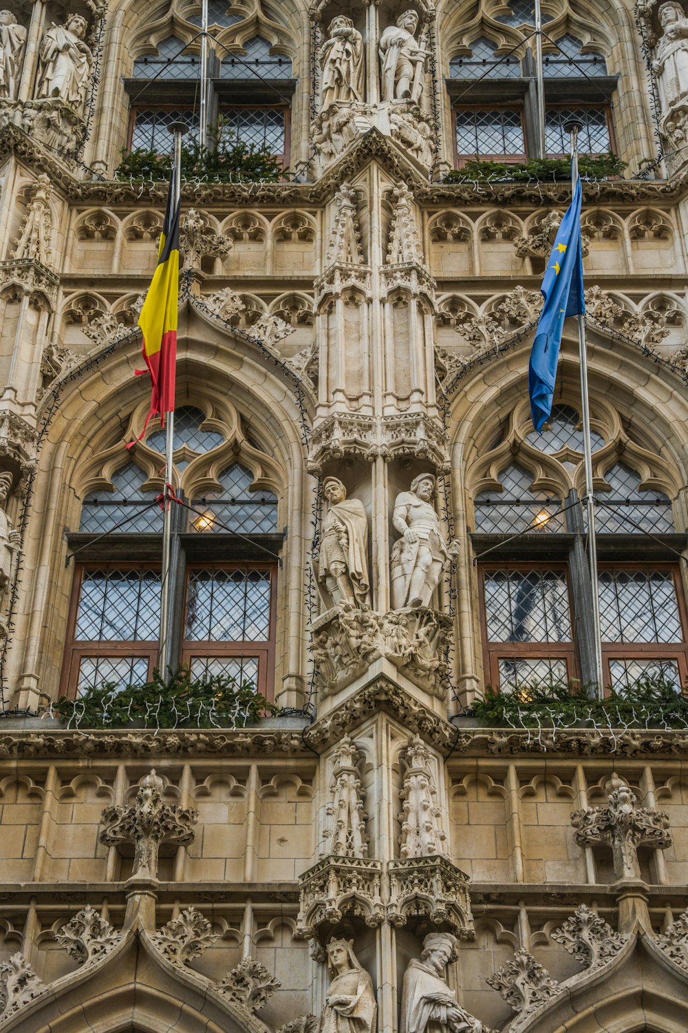 a tall building with many windows and flags