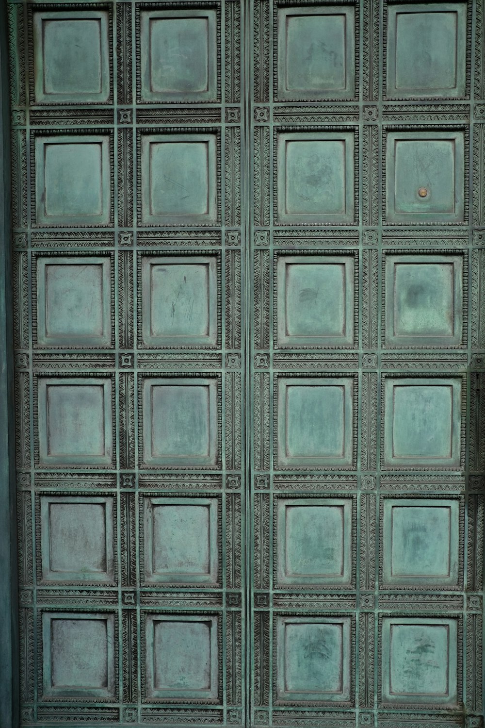 a close up of a metal door with squares on it