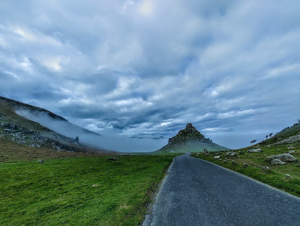 a road with a mountain in the background