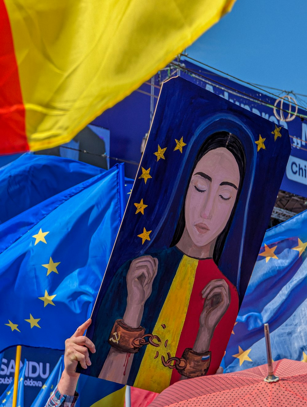 a woman holding up a painting of a woman