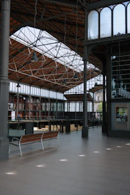 Interior view of a spacious metal building featuring exposed beams and modern rustic decor.