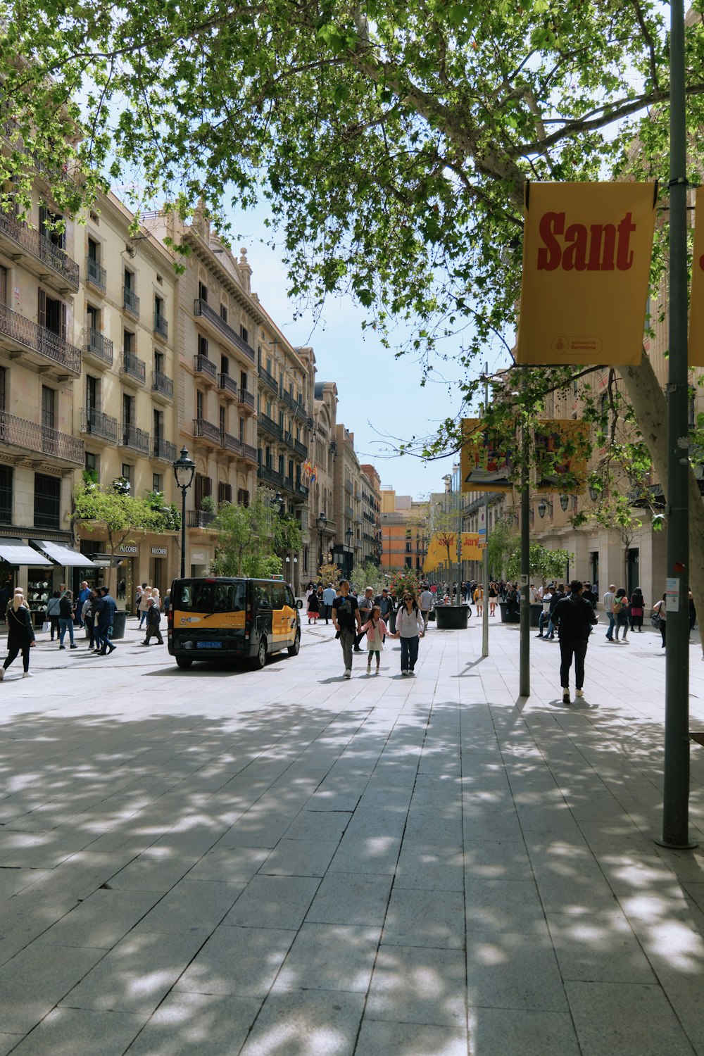 a street scene with people walking on the sidewalk