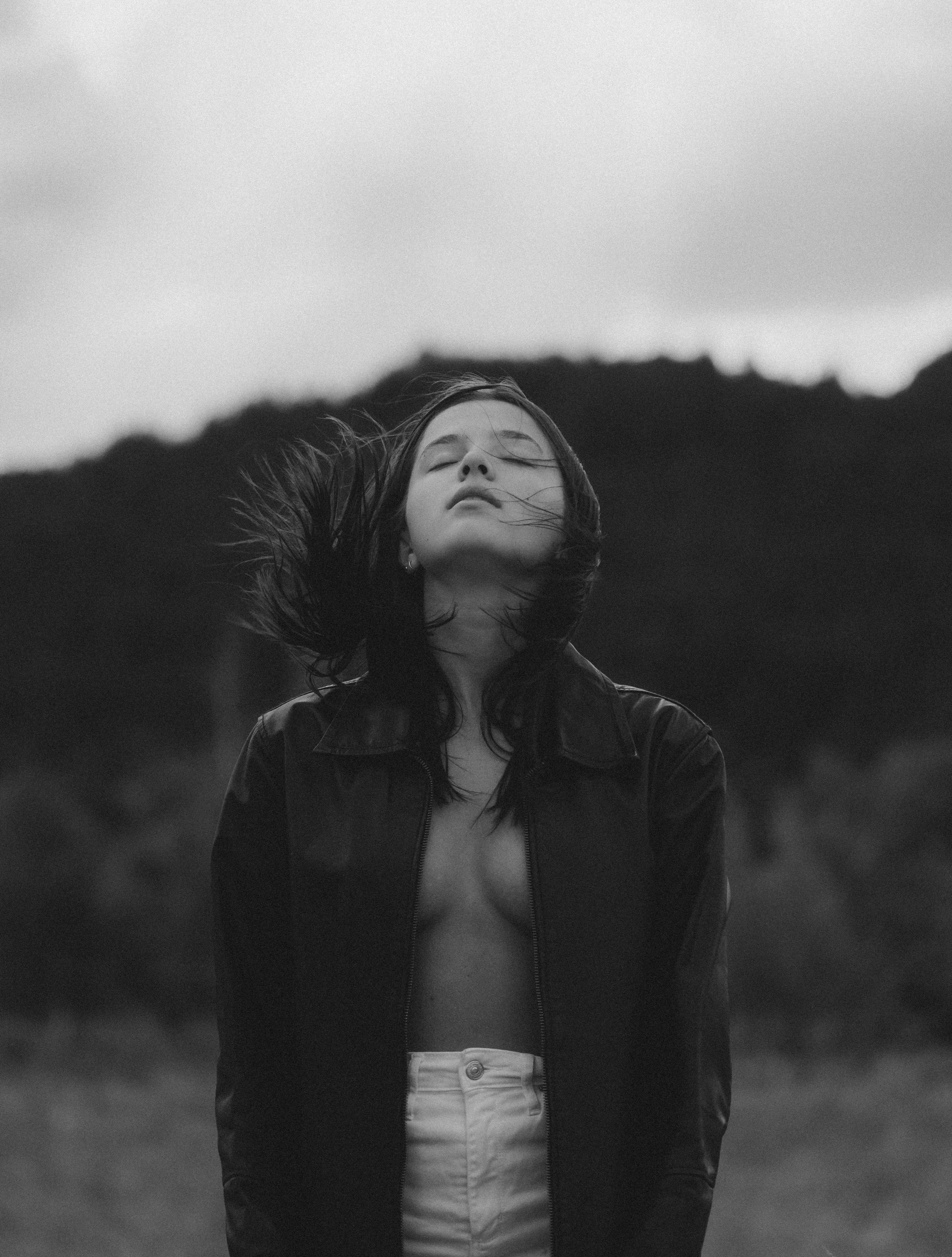 a black and white photo of a woman with her eyes closed
