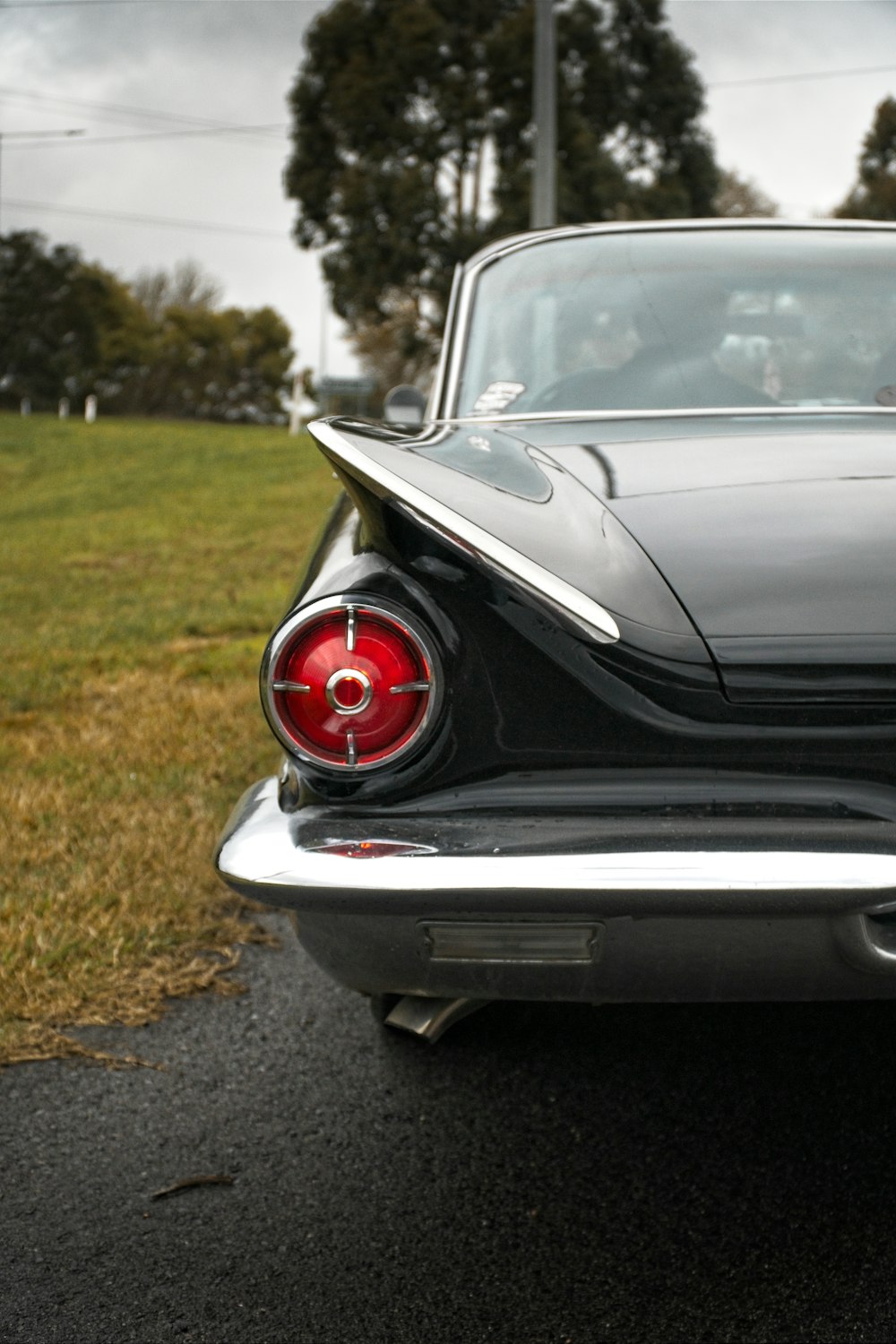 a black car parked on the side of the road