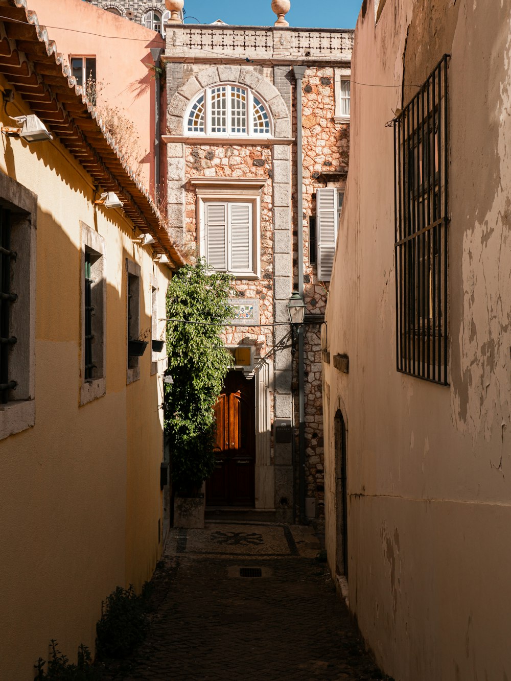a narrow alley way with a building in the background