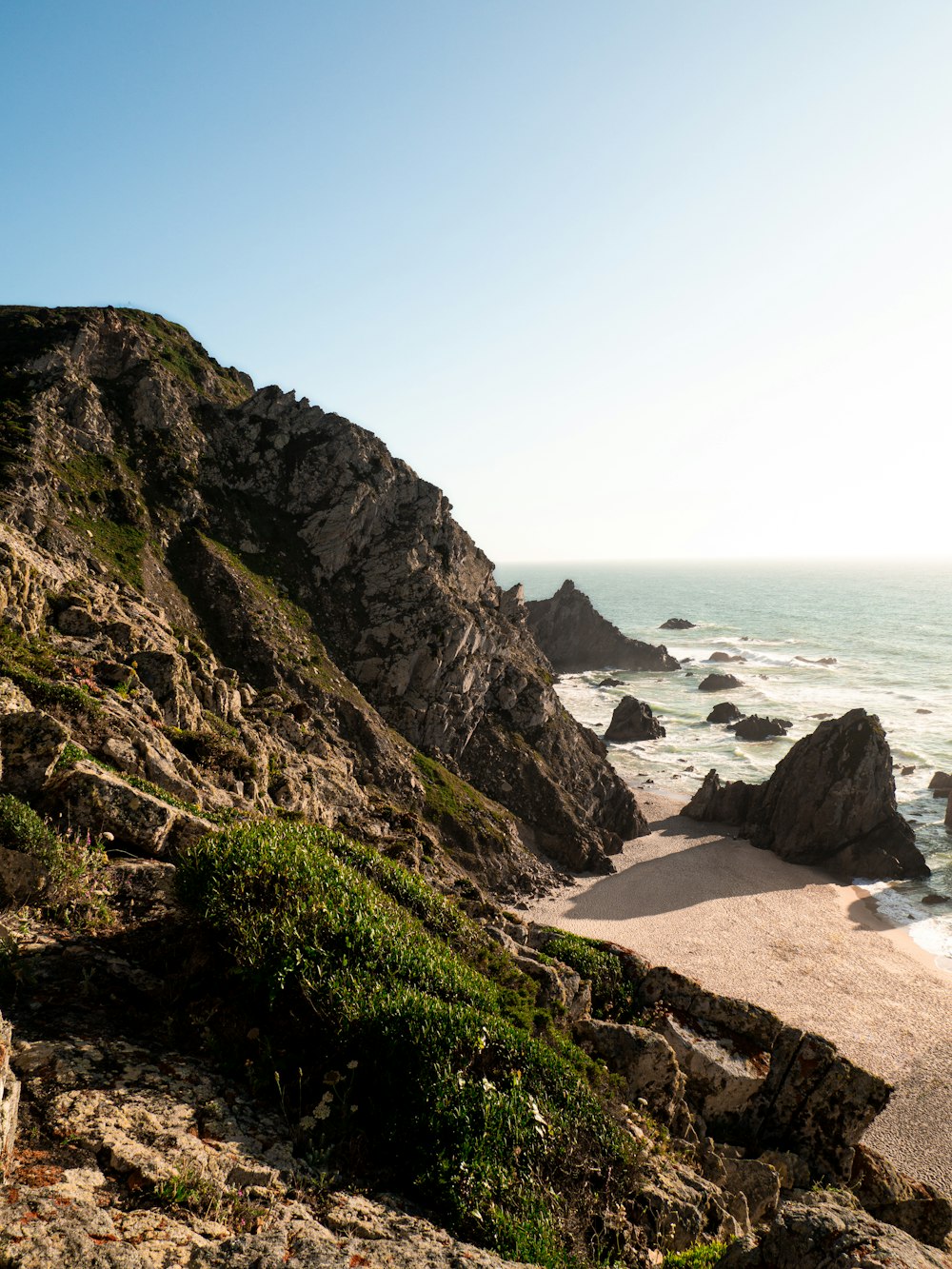 a view of the ocean from the top of a hill