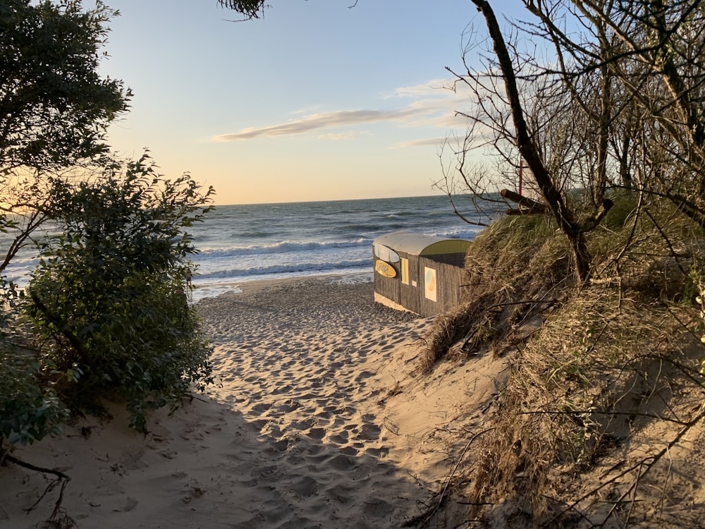 a boat sitting on top of a sandy beach