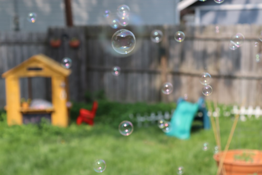 bubbles are floating in the air in a backyard