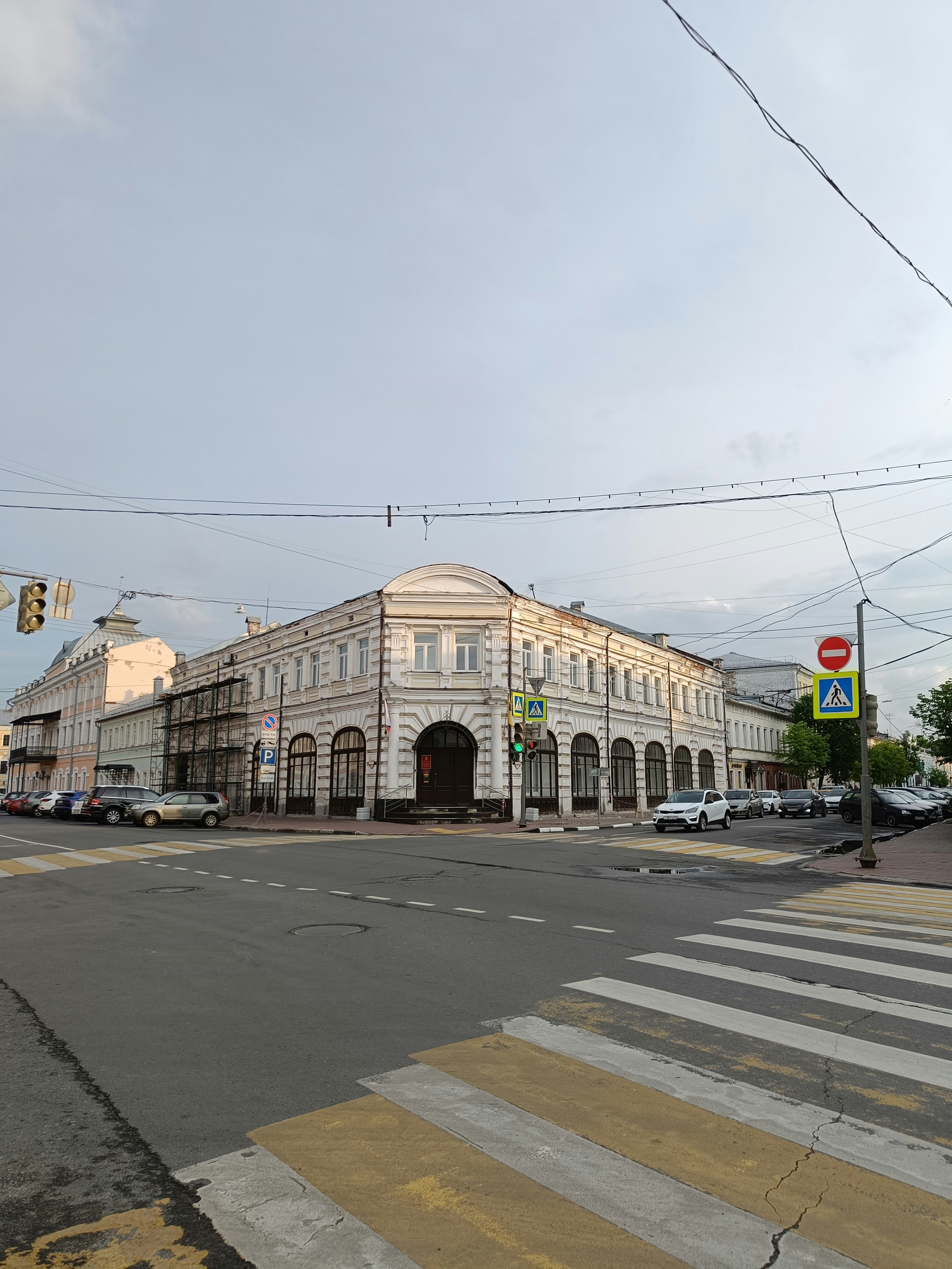 a large white building sitting on the side of a road