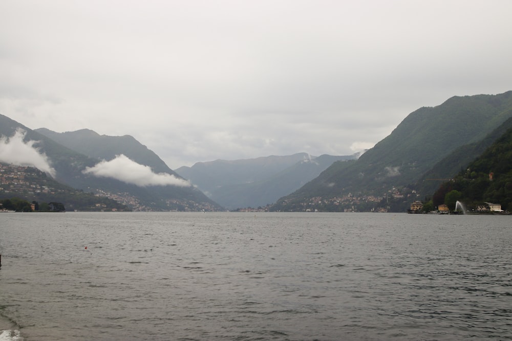 a body of water with mountains in the background