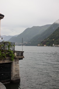 Balcony view showing peaceful lake and mountains.