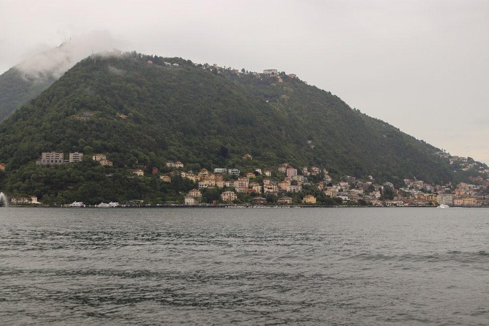 a large body of water with a mountain in the background