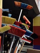 a bunch of brooms that are outside of a building