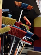 a bunch of brooms that are outside of a building