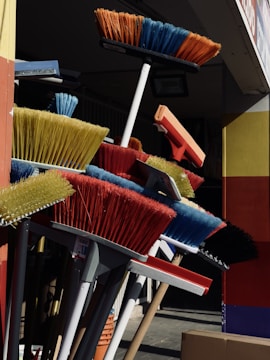 An artistic display of various handcrafted brooms.
