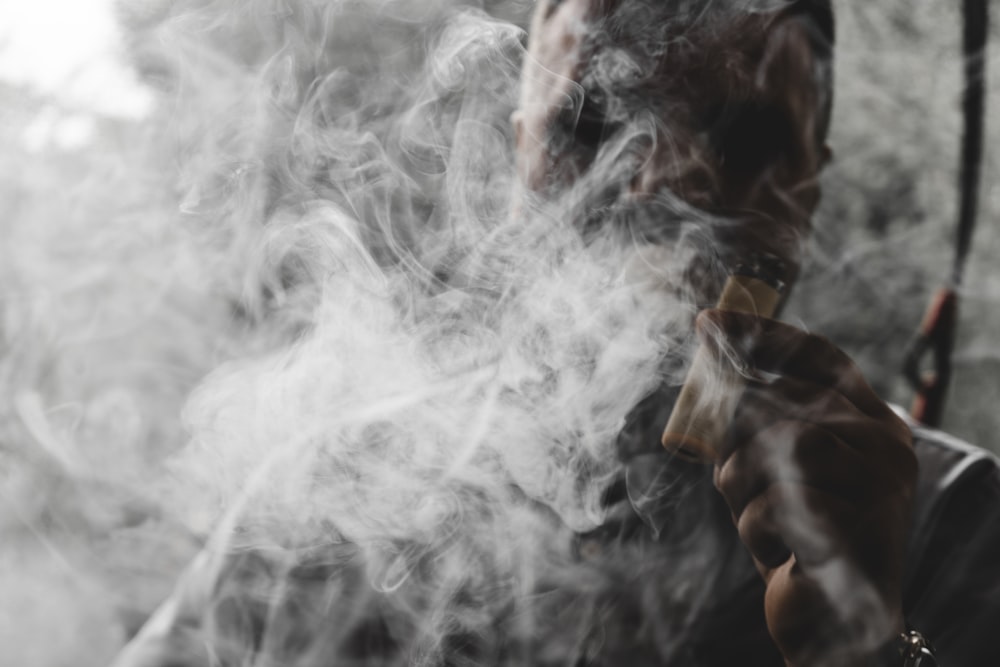 a man smokes a cigarette in a black and white photo