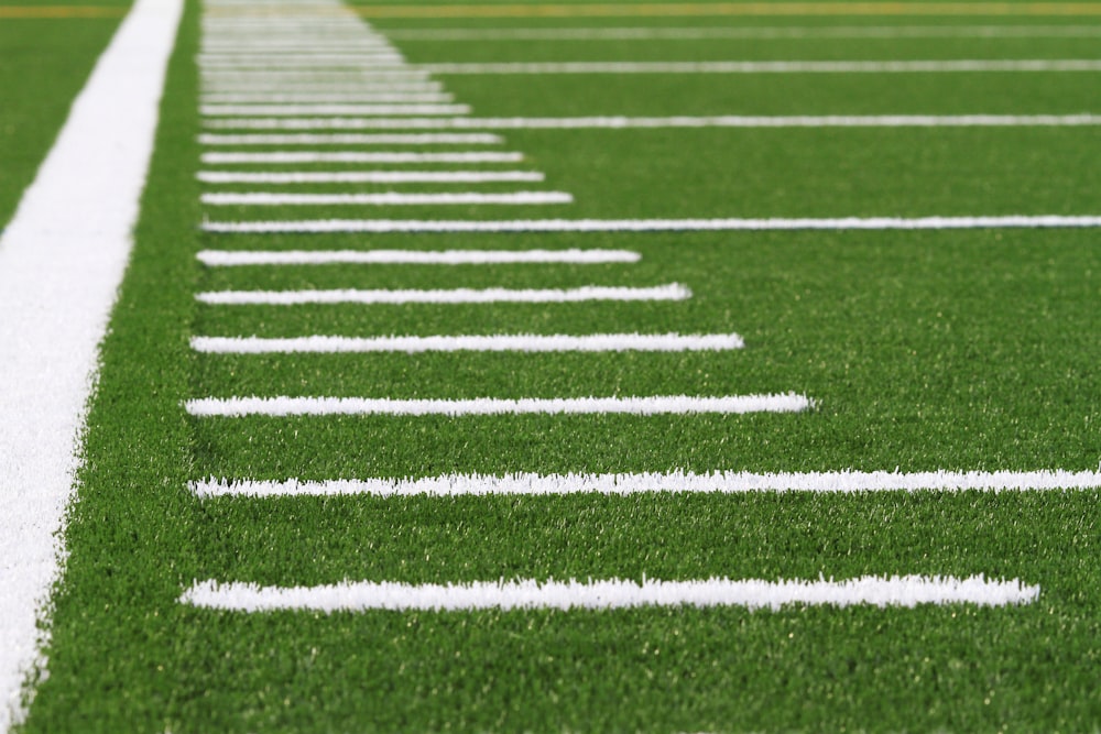 a line of white lines on a green field