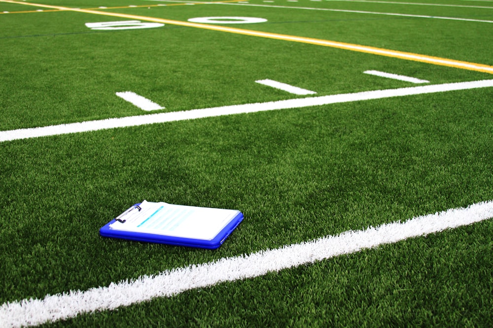 a notebook sitting on the side of a football field