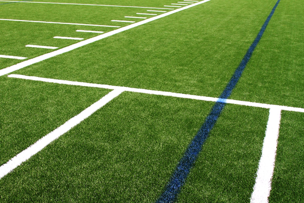 a green field with white lines and blue lines