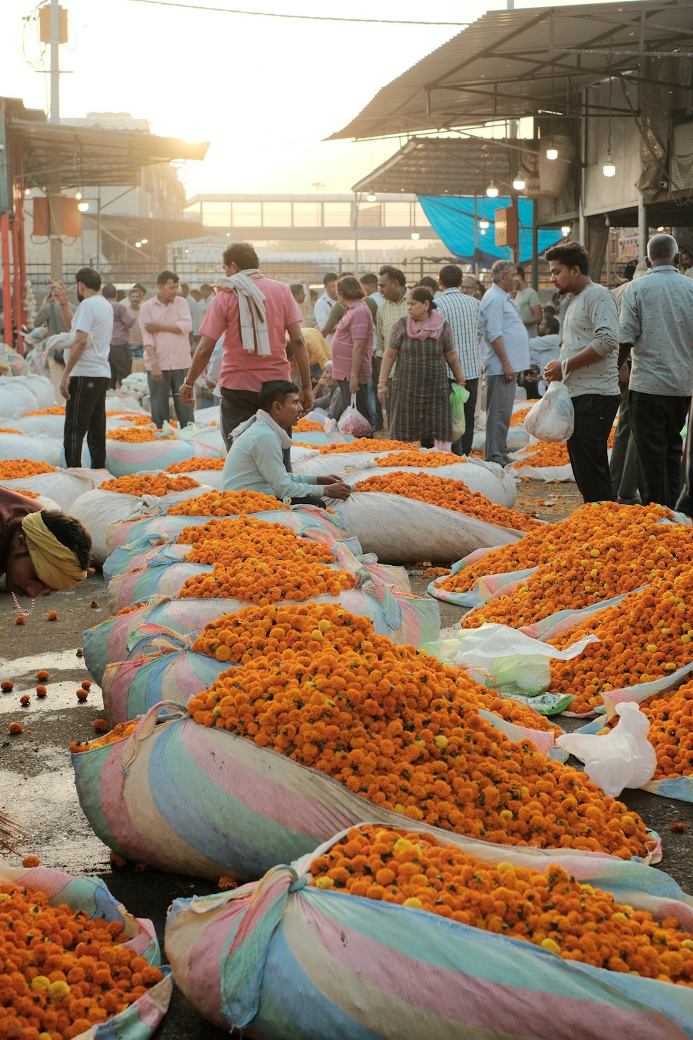 a group of people standing around bags of flowers